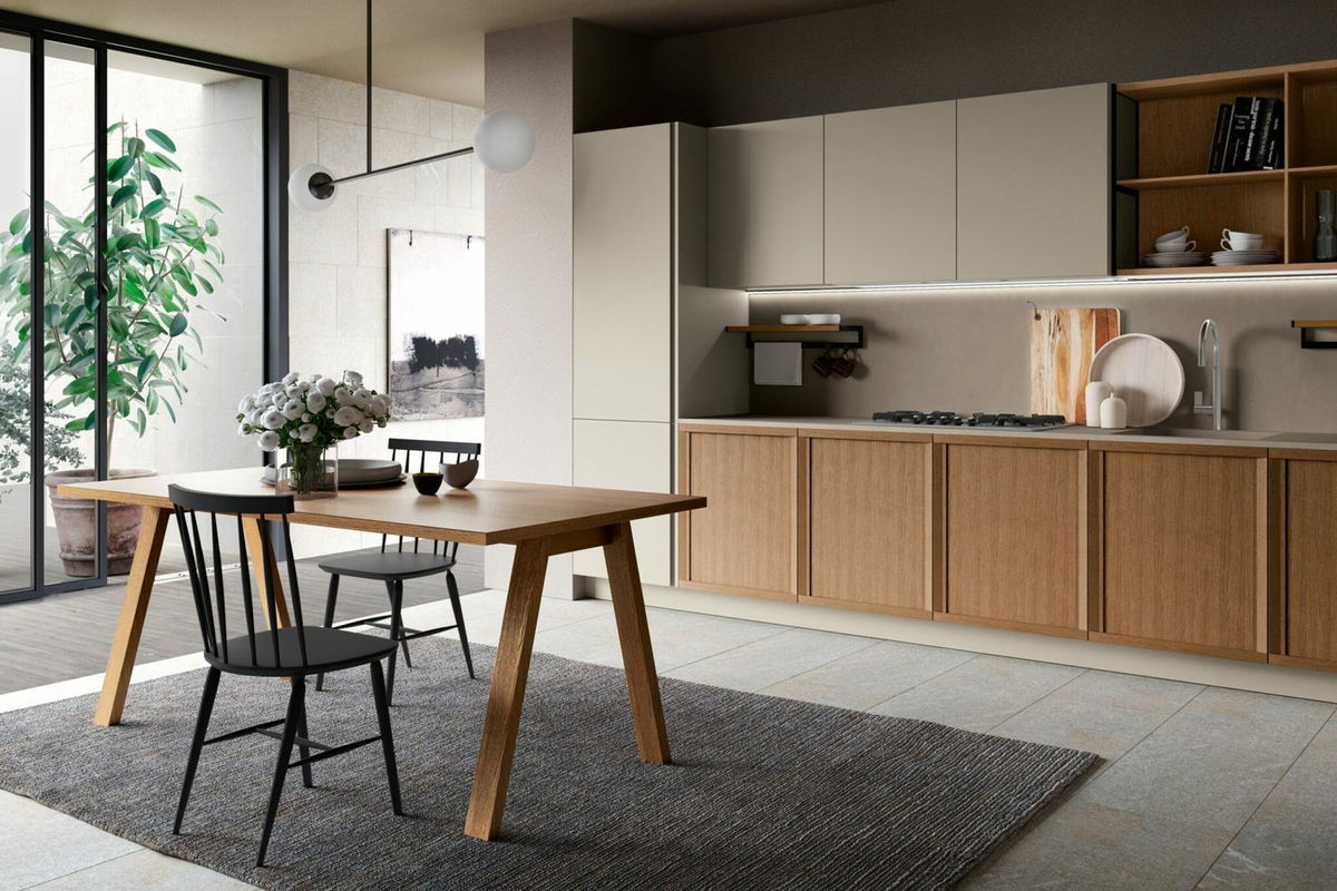 Oak and cream kitchen with an oak dining table and black chairs
